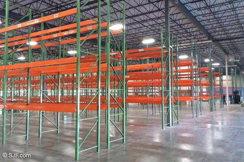 Used teardrop pallet rack beams installed in a warehouse setting
